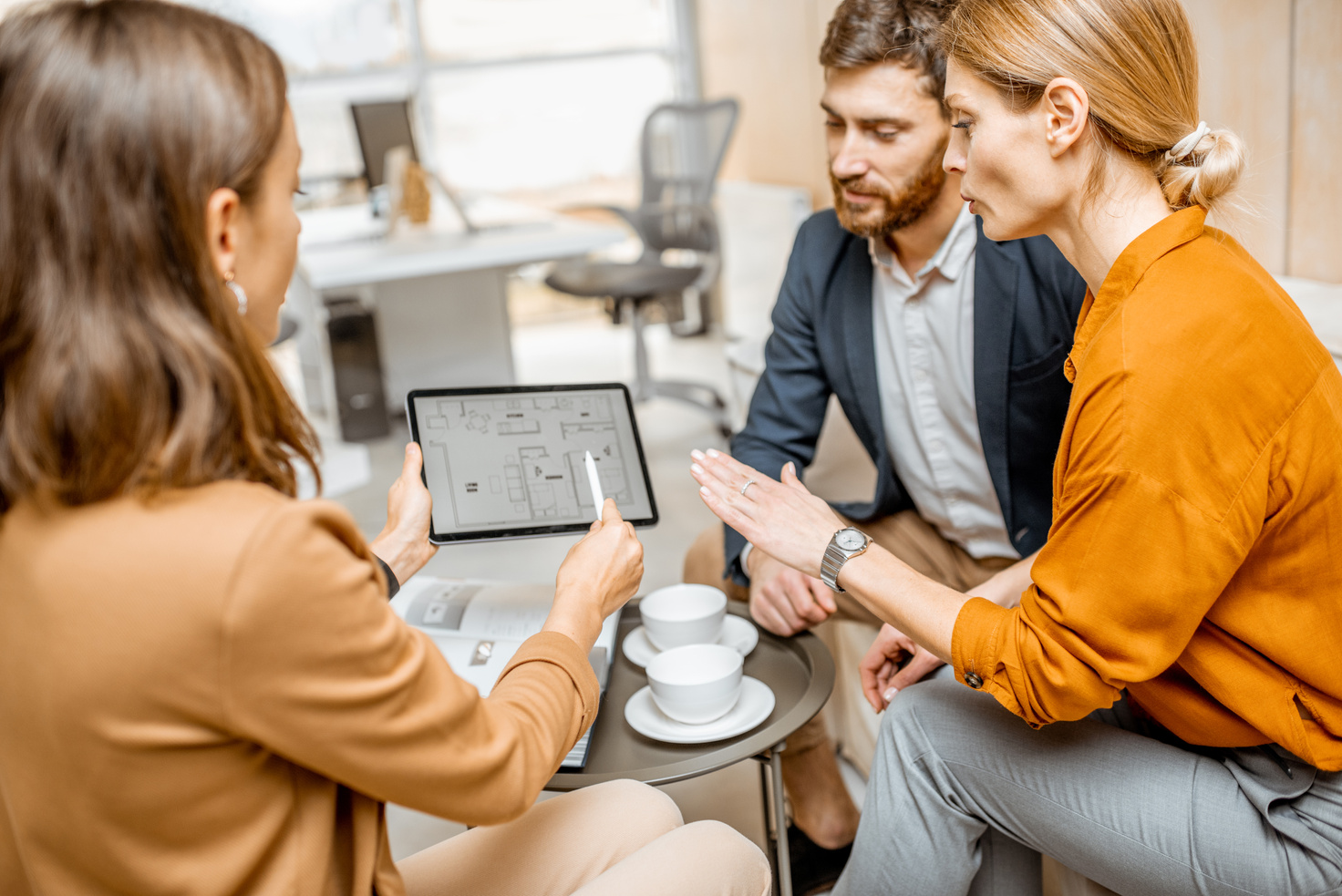 Young Couple Choosing House at the Real Estate Agency